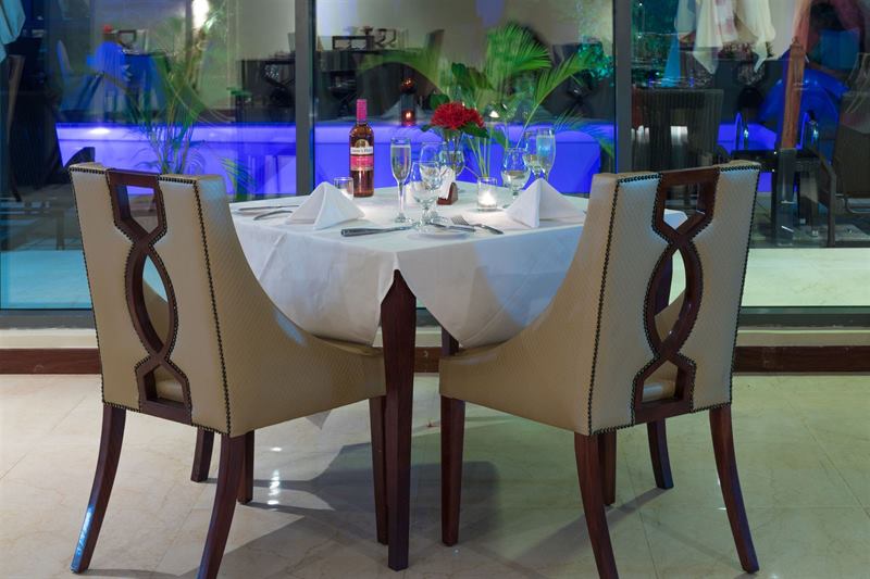 Table for two beside the pool in the evening